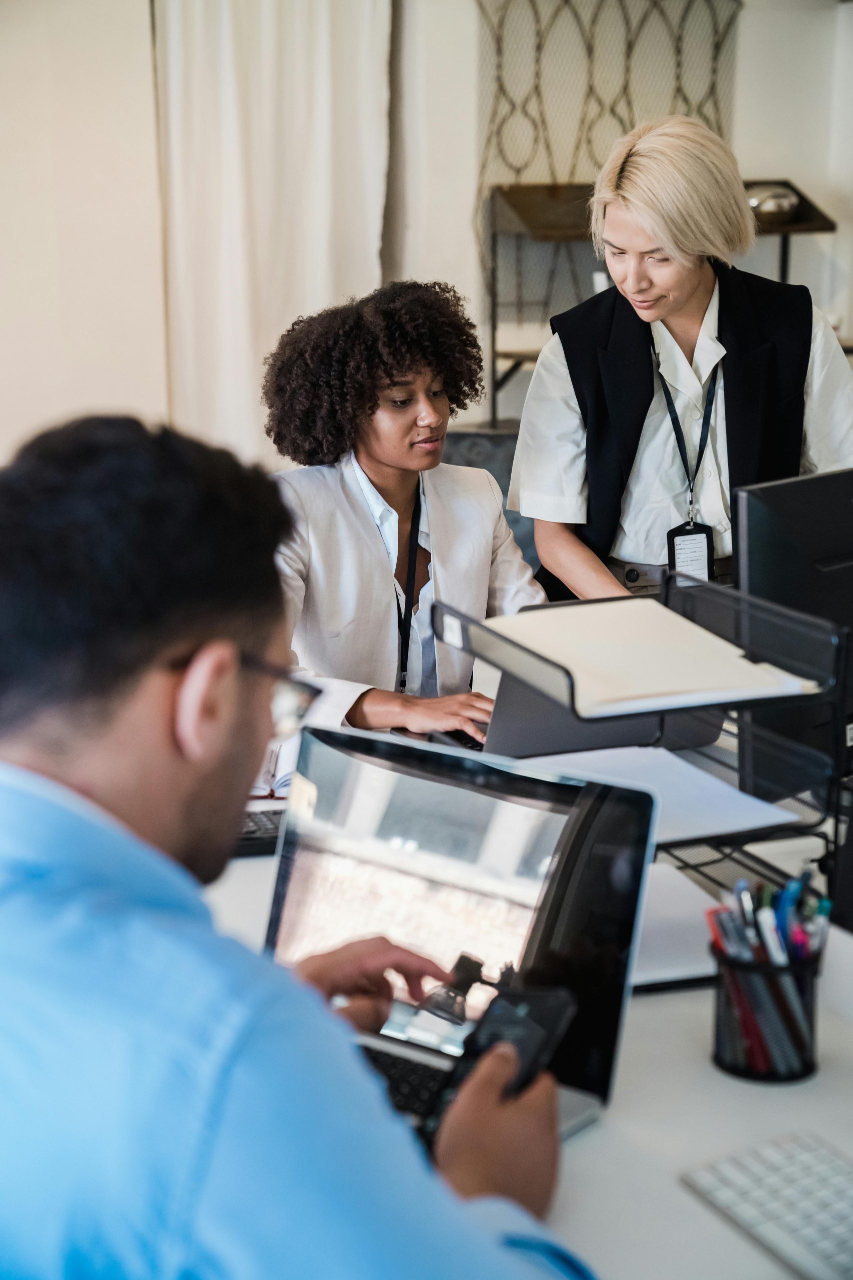 A diverse group of professionals working together in a contemporary office setting, showcasing teamwork and collaboration.
